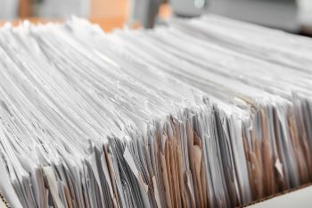 Closeup photo of paper documents in an archive box