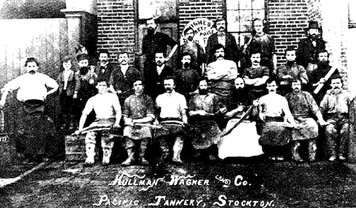 Kullman Wagner Co employees in front of pacific tannery 1877 A vintage photo of a group of people sitting infront of a brick building. The words "Kullman Wagner and Co. Pacific Tannery, Stockton" are printed on the photo.