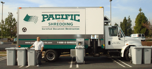 A Pacific Shredding Mobile Shredding Truck with multiple Secure Collection Containers lined up in front.