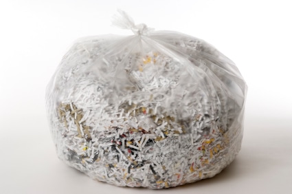 A clear plastic bag full of shredded paper