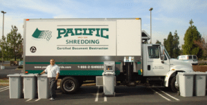 A Pacific Shredding Mobile Shredding Truck with multiple Secure Collection Containers lined up in front.